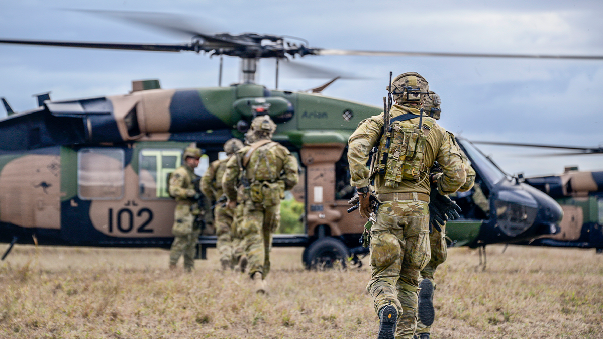 Soldiers walking towards Blackhawk helicopter