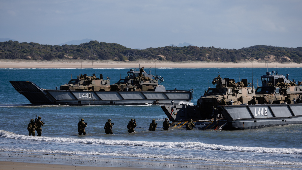 Australian Army soldiers and Bushmaster Protected Mobility Vehicles are loaded onto LHD Landing Crafts during the reconstitution of the Australian Amphibious Force during Exercise Sea Raider 2023.