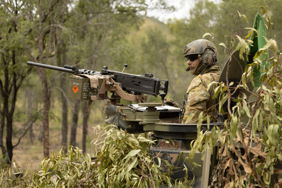 Australian Army soldier from the 2nd Cavalry Regiment stands in his Australian Light Armoured Vehicle before commencing a live-fire serial in the Townsville Field Training Area during Exercise Eagle March.