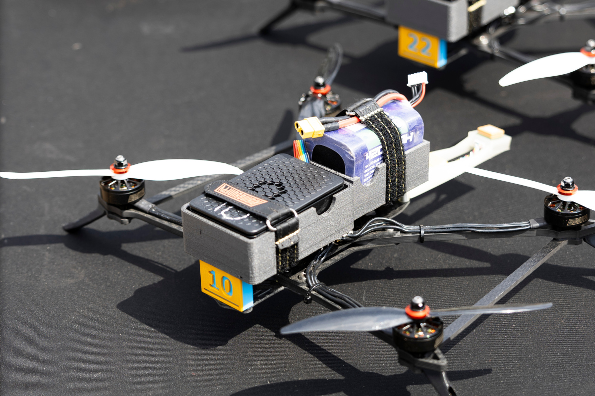 Australian Army officers from the Combat Training Centre and Cubic Defence Australia display a Cubic swarm variant drone as part of new live integrated systems at Townsville Field Training Area, Queensland on 13 September 2025.