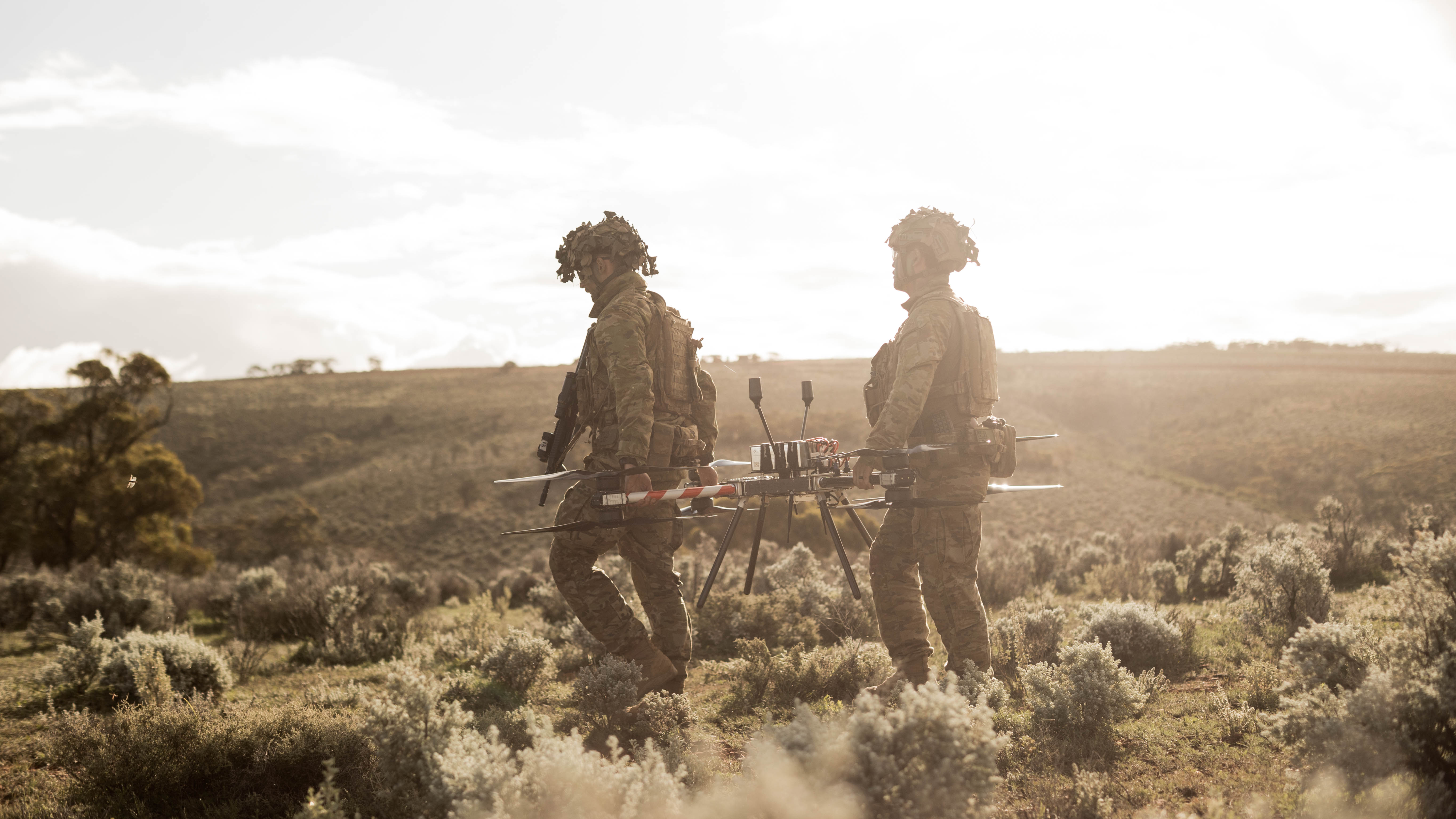 Australian Army soldiers, Corporal Joshua Clegg (left) and Craftsman Jeremy Tjong, 1st Armoured Regiment, position the Callisto 50 heavy-lift uncrewed aerial system ahead of launch at Cultana Training Area during Exercise Black Prince 3.