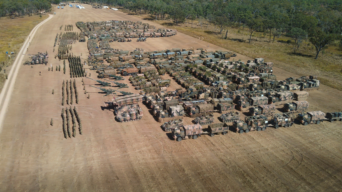 Personnel from the Australian Army, United States Army, United States Marine Corps, Japan Ground Self-Defense Force, Republic of Korea Armed Forces and Papua New Guinea Defence Force stand together at the opening ceremony of Exercise Southern Jackaroo at the Townsville Field Training Area, Queensland.