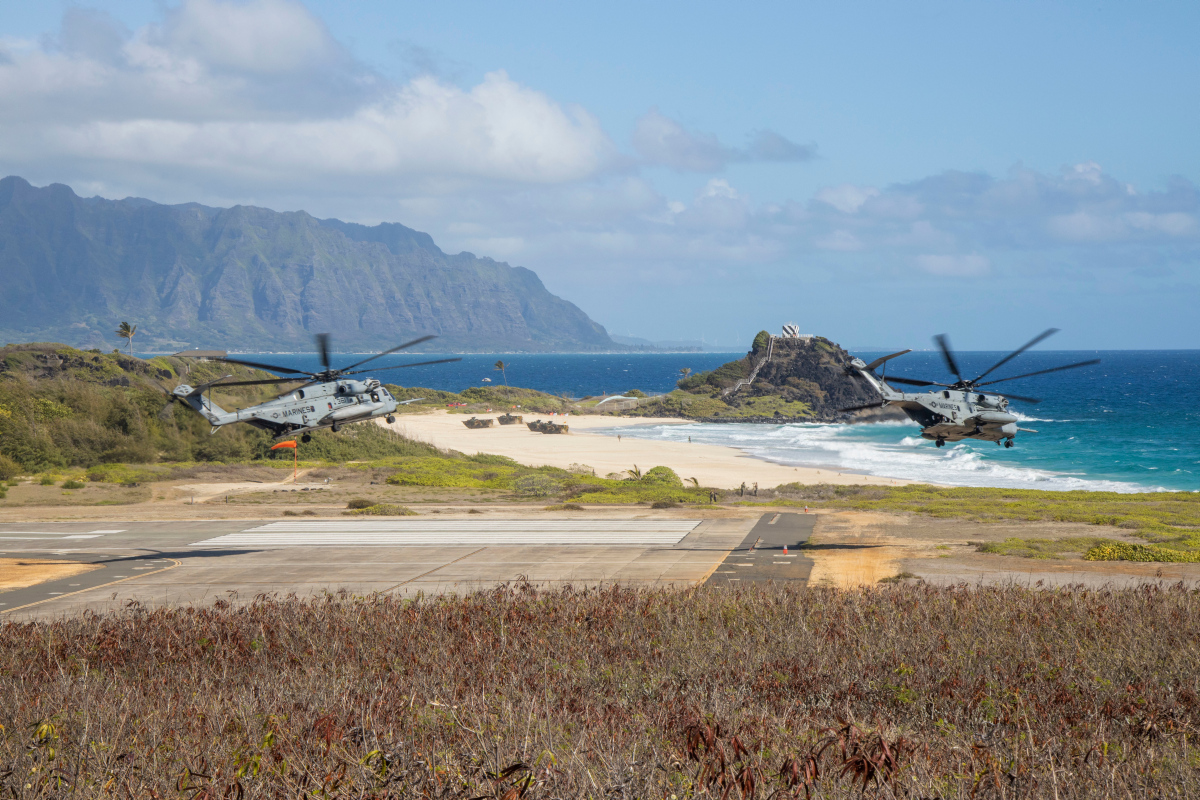 U.S. Marine Corps MV-22 Ospreys and CH-53E Super Stallions land during an amphibious raid for a multinational littoral operations exercise as part of Rim of the Pacific (RIMPAC) 2022.