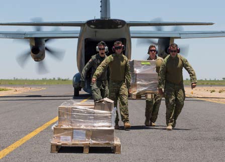 Members of an Army Petroleum Operations platoon work with RAAF C-27J Spartan aircrew to coordinate deliveries of equipment during Operation Queensland Flood Assist.