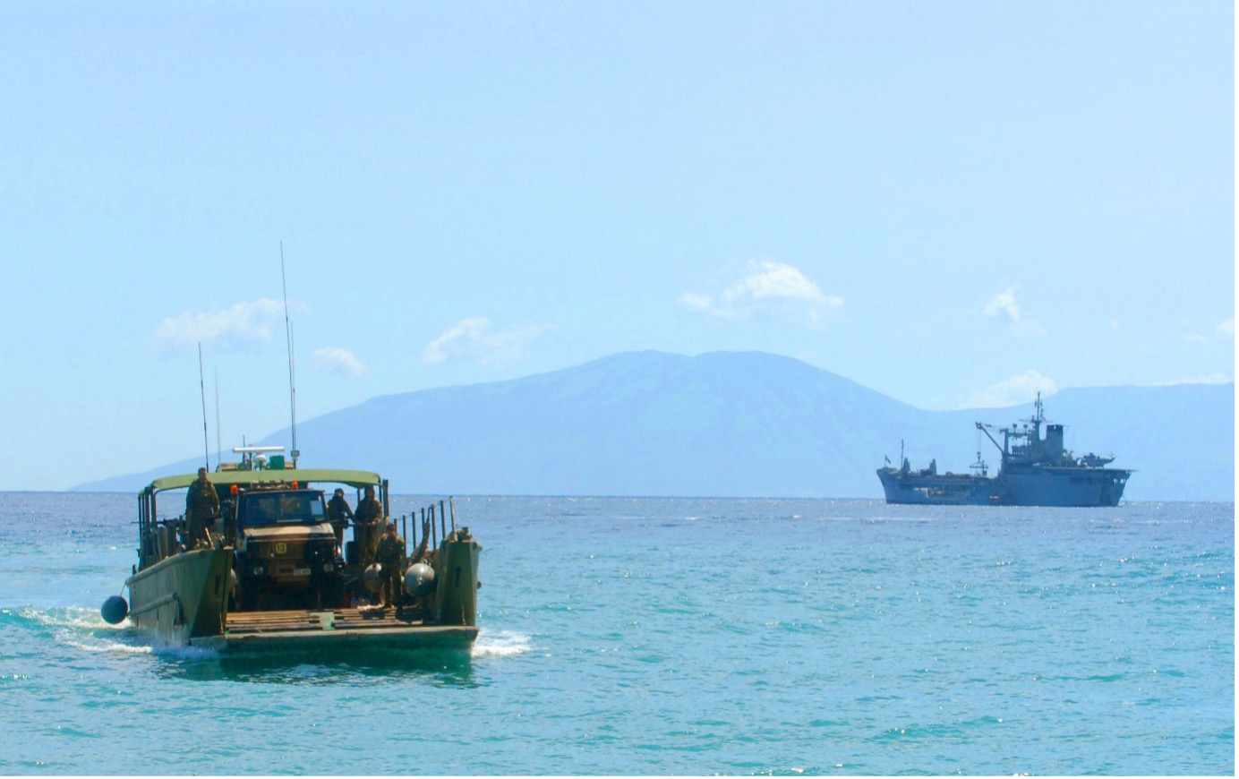 An Australian Army Unimog truck is transported on an Australian Army Landing Craft Mechanised