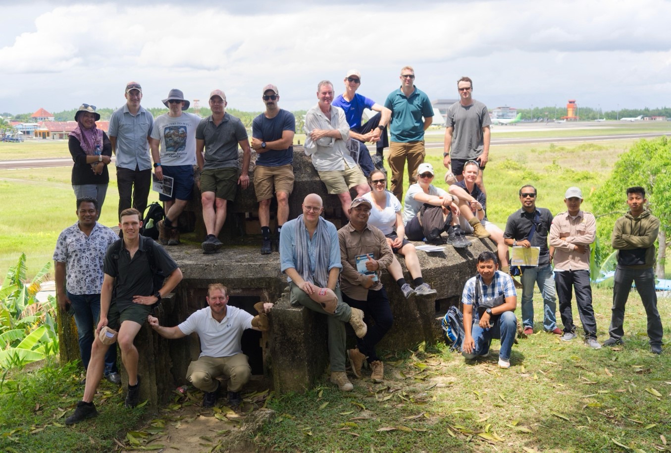 Photograph of staff ride group at old bunker, Tarakan airstrip