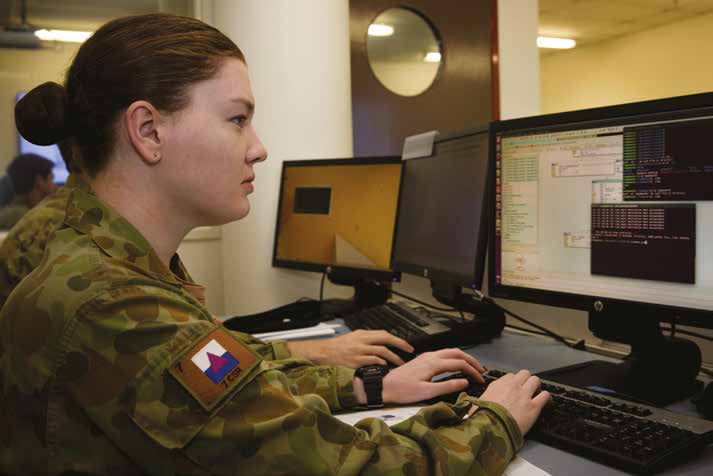 Female officer sitting working at a computer.