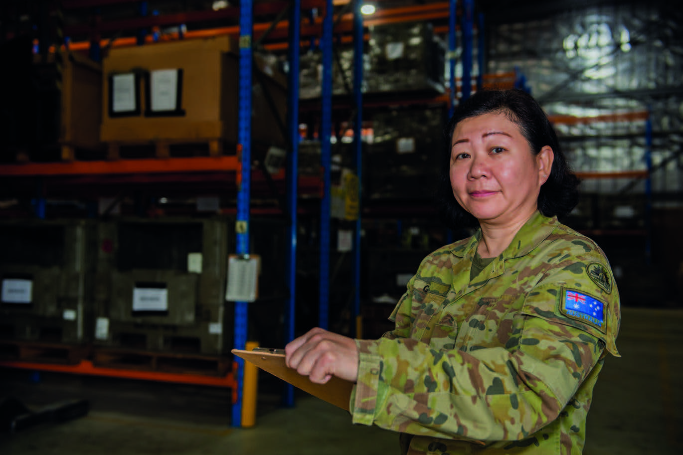 Soldier checking stock in a warehouse.