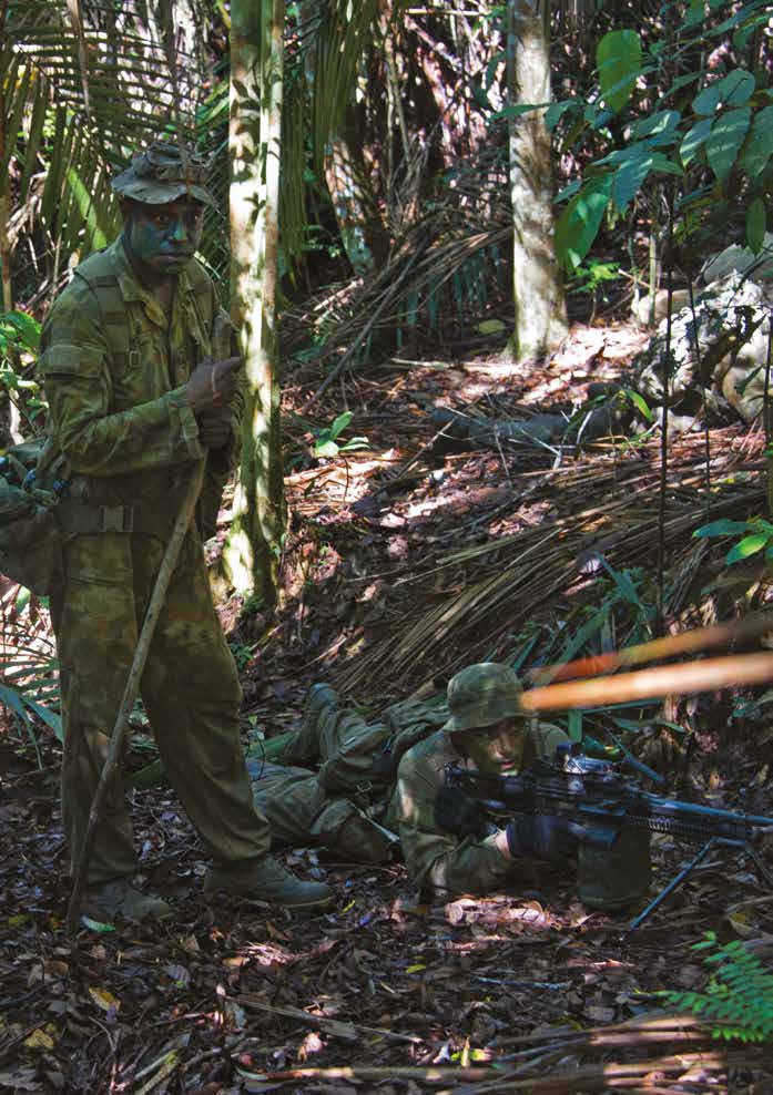 Two Australian Soldiers are out the field at a machine gun position.