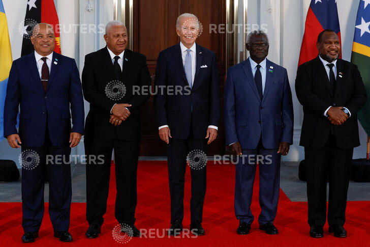 U.S. President Joe Biden poses with Federated States of Micronesia's President David Panuelo, Fiji's Prime Minister Frank Bainimarama, Solomon Islands Prime Minister Manasseh Sogavare and Papua New Guinea's Prime Minister James Marape and other leaders from the U.S.- Pacific Island Country Summit, at the White House in Washington, U.S. September 29, 2022. The leaders are all facing the camera and wearing suits.