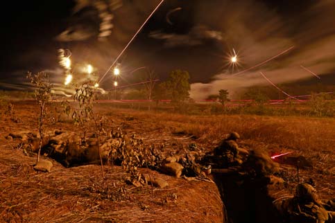 Flares and tracer light the sky during a live-fire exercise.