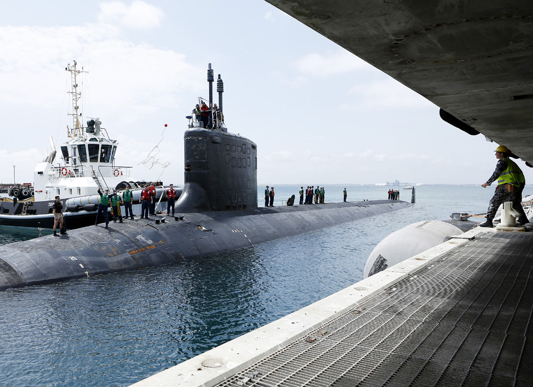 Port Services personnel wait in preparation as Collins Class Submarine HMAS Sheean comes alongside Diamantina Pier at Fleet Base West after being deployed for five months.