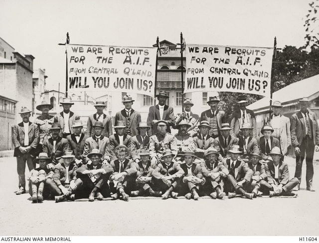 Recruits from Rockhampton and district, pictured with recruiting banners in Brisbane before entering camp. The banners read: "We are the recruits for the AIF from Central Q'land [Queensland] will you join us" and may have been used in one of the recruitment marches which happened around Australia. Published in the Queenslander 24 November 1917, page 22, the original caption reads "A party of recruits from Rockhampton who recently marched through Brisbane to help the volunteer movement. F W Thiel photo."