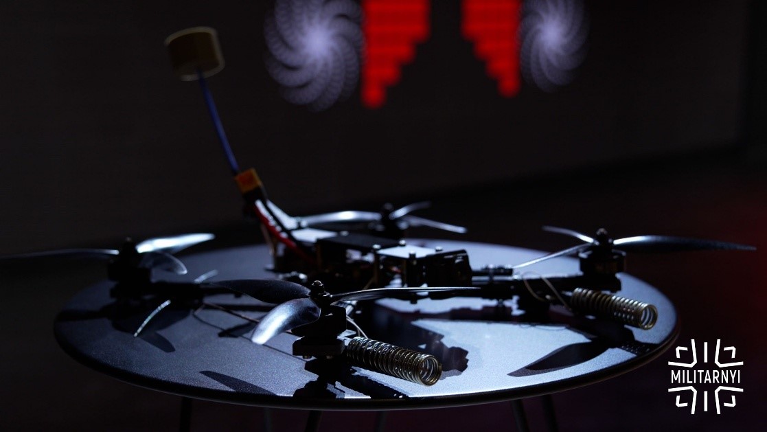 An all-Ukrainian FPV drone produced by Vyriy Drone on a table, under a spotlight with a dark background