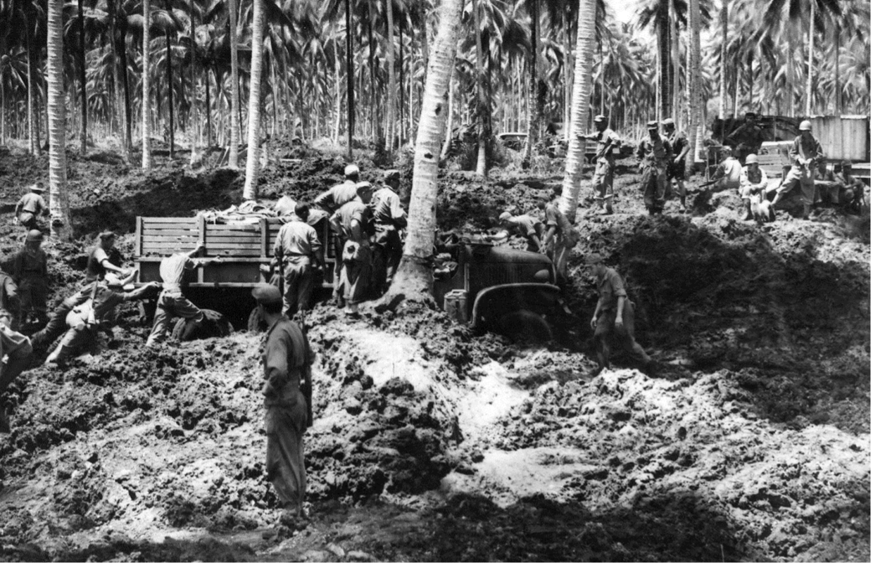 Soldiers work to free a truck that is bogged