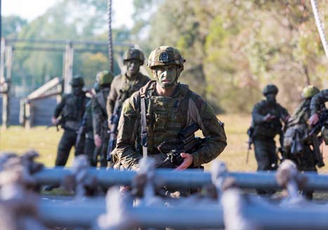 Soldiers negotiate an obstacle course.