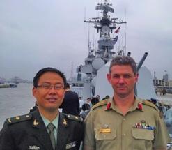 COL Connolly onboard a naval ship with an international colleague.