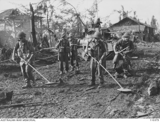 Sappers of the 2/9th Field Company, Royal Australian Engineers, search for landmines to allow Matilda tanks of the 1st Armoured Regiment to go forward – an example of the cooperation between all units essential in the Balikpapan operation.