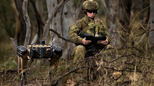 Australian Army soldier Corporal Meg Reeves uses a Ghost Robotics quadruped robot for a reconnaissance task at Mount Pleasant, Canberra.