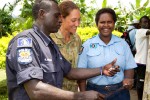Australian Army Sergeant Jasmine Johnston reads over Operation RENDER SAFE 14 safety messages with Bougainville Police Officers Simon Sireung and his wife Lynn, during a community engagement activity in the Torokina District.