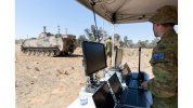 Australian Army soldier from the School of Armour, remotely controls an autonomous M113 AS4 optionally crewed combat vehicle (OCCV) at the Majura Training Area, Canberra..