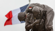 French Cobbers statue in foreground with French National flag flying to left in background