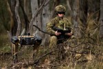 Australian Army soldier Corporal Meg Reeves uses a Ghost Robotics quadruped robot for a reconnaissance task at Mount Pleasant, Canberra.