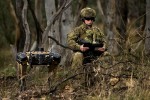 Australian Army soldier Corporal Meg Reeves uses a Ghost Robotics quadruped robot for a reconnaissance task at Mount Pleasant, Canberra.
