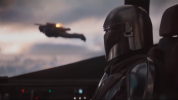 A pilot looking outisde the cockpit window at a person flying with a jetpack