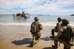 Australian Army soliders from 10th Force Support Battalion's Amphibious Beaching Team await the arrival of troops on an Lighter Landing Craft during Exercise Trident 2022 near Shoalwater Bay Training Area, Queensland.