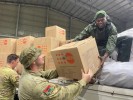 Private Zed Barrett (left) and Private Luke Smith (centre) assist a member of the Vanuatu Mobile Force with the unloading of dignity kits for local Vanuatu communities in Port Vila during Operation Vanuatu Assist 2023.