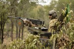 Australian Army soldier from the 2nd Cavalry Regiment stands in his Australian Light Armoured Vehicle before commencing a live-fire serial in the Townsville Field Training Area during Exercise Eagle March.
