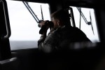 Lieutenant Nicholas Newton, RAN takes a bearing as HMAS Brisbane and Philippine Navy Ship BRP Jose Rizal conduct Officer of the Watch Manoeuvrers during Exercise ALON 2025.