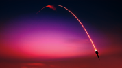 Rocket with trail and red sunset background