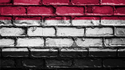 Brick wall painted in red, white and black horizontal stripes