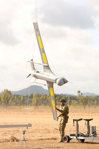 Australian Army soldier, Lance Bombardier Liam Wilson, from 20th Regiment, Royal Australian Artillery removes the Integrator Tactical Uncrewed Aerial System from the skyhook at Shoalwater Bay, Rockhampton, Queensland.