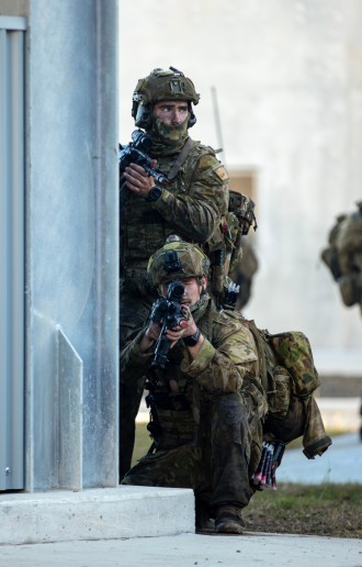 Australian Army soldiers from the 1st Battalion, The Royal Australian Regiment conduct a raid on the Urban Operations Training Facility as a part of Exercise Sea Raider.