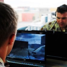 Corporal Silvester (facing) and Signalman Rowe - with wireless networked laptops - play Call of Duty during some downtime at the end of another day at their base in Tarin Kowt, Afghanistan.