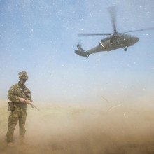 Australian Army soldier Corporal Donovan Murphy provides force protection as Commanding General Combined Joint Forces Land Component Command – Operation Inherent Resolve Major General Gary J. Volesky departs the Taji Military Complex in Iraq aboard a United States Blackhawk helicopter.