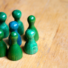 Green standing pegs surrounding a blue standing peg