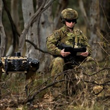 Australian Army soldier Corporal Meg Reeves uses a Ghost Robotics quadruped robot for a reconnaissance task at Mount Pleasant, Canberra.