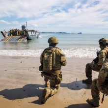 Australian Army soliders from 10th Force Support Battalion's Amphibious Beaching Team await the arrival of troops on an Lighter Landing Craft during Exercise Trident 2022 near Shoalwater Bay Training Area, Queensland.