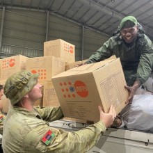 Private Zed Barrett (left) and Private Luke Smith (centre) assist a member of the Vanuatu Mobile Force with the unloading of dignity kits for local Vanuatu communities in Port Vila during Operation Vanuatu Assist 2023.
