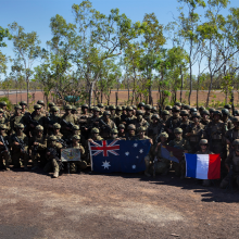 French and Australian soldiers with their countries' flags.