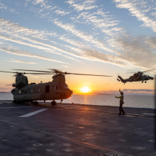 Australian Army Reconnaissance Helicopter (ARH-Tiger) from the 1st Aviation Regiment approaches the deck of HMAS Adelaide alongside a CH-47F Chinook Helicopter from the 5th Aviation Regiment during deck landing certifications off Townsville during Exercise Sea Wader 2020.