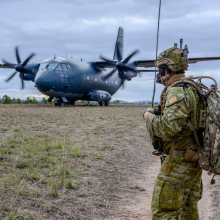A Royal Australian Air Force airman talks to the C-27J Spartan aircraft crew as they prepare to depart High Range training area near Townsville, Queensland, during Exercise Talisman Sabre 2019.