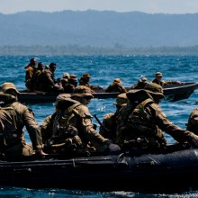 Small boat patrol teams on water.