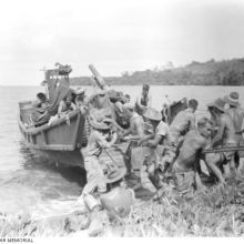Biamu, Oro Bay, New Guinea. 1942-11-11. Gunners of the 2/5th Field Regiment unloading their 25 pounder gun at Biamu Village. This gun is being unloaded from a Japanese barge which was captured during the abortive landing attempt at Milne Bay during 1942-08/07. Source: Australian War Memorial