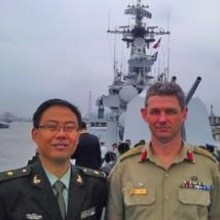 COL Connolly onboard a naval ship with an international colleague.