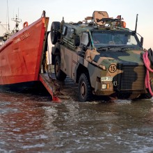 The 1st Combat Service Support Battalion’s Littoral Beach Team manoeuvre a Protected Mobility Vehicle off the MV Cooma Cooma at Gunn Point, NT as part of Exercise Predator's Run 2023.